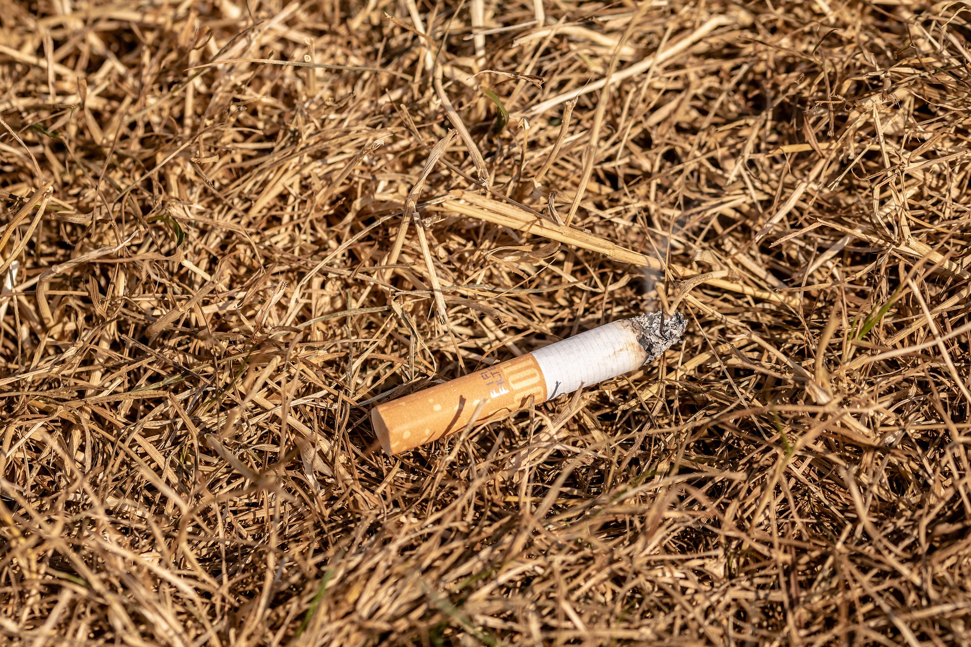 Smoldering cigarette on floor