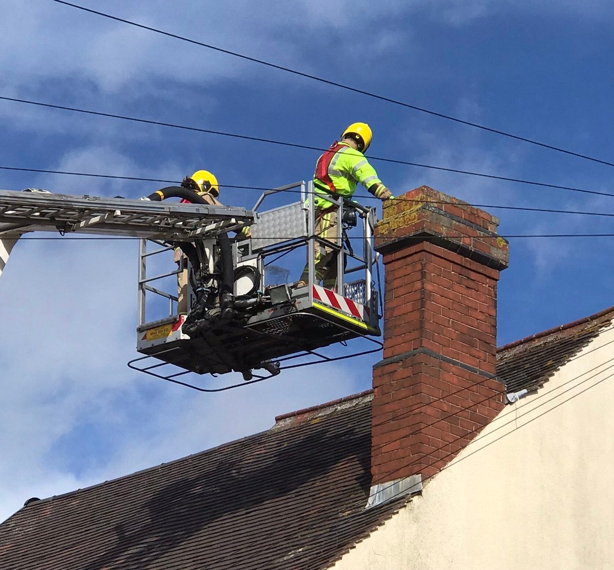 Firefighters looking in chimney from ALP