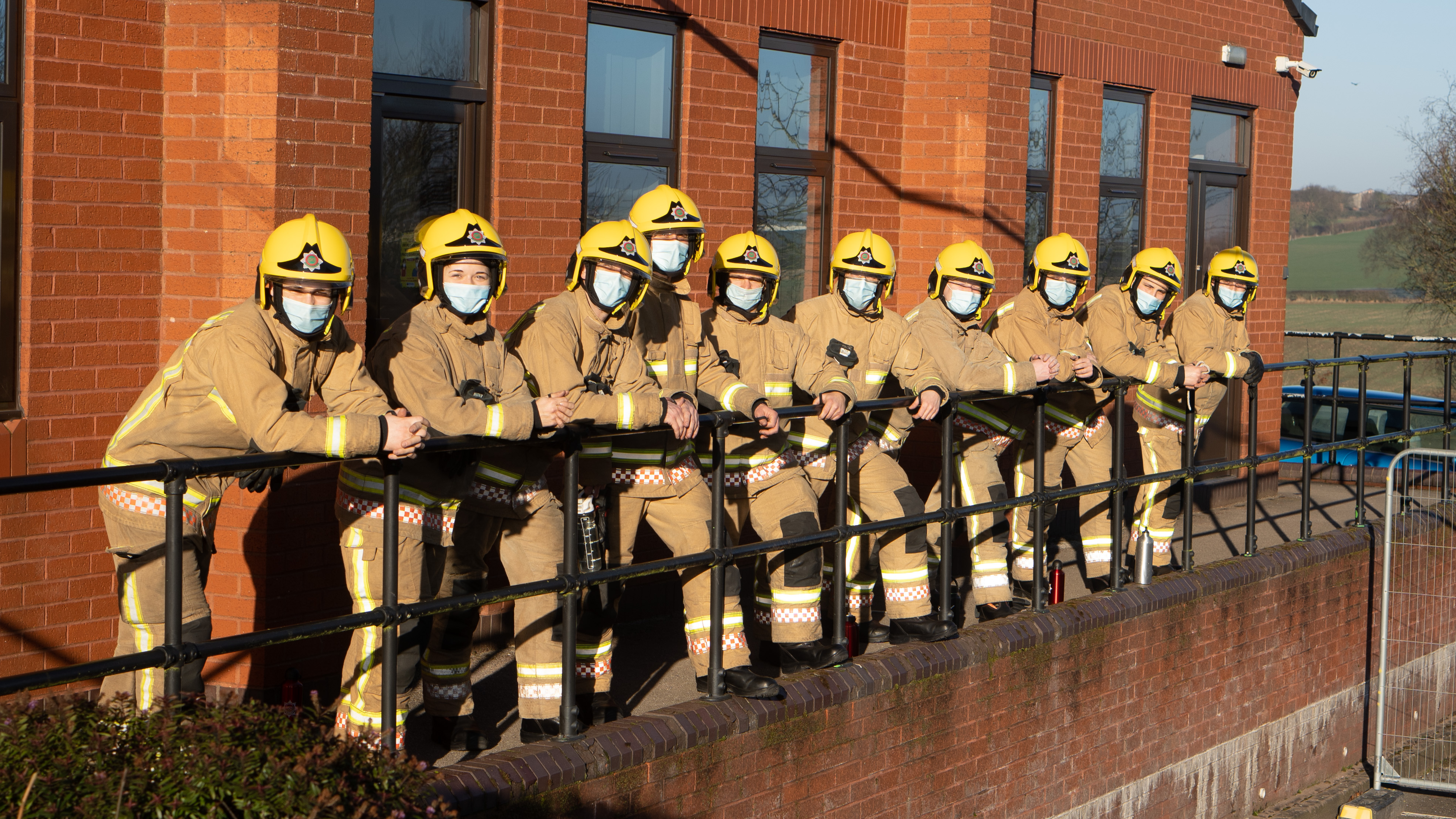 Firefighters lined up wearing masks