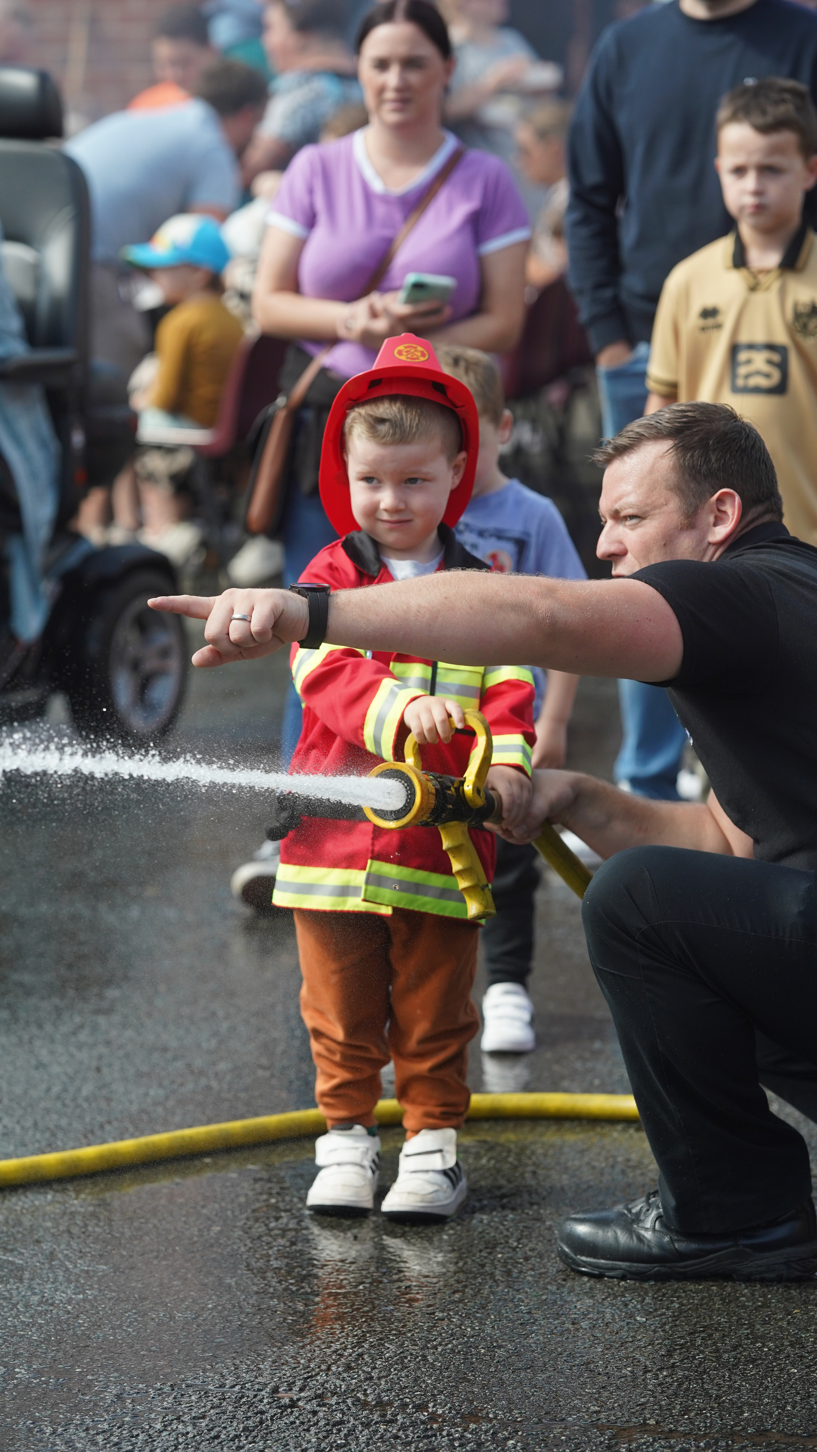 Boy and firefighter at event