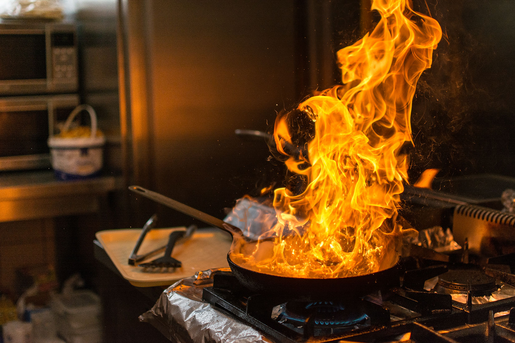 Frying pan on fire in kitchen