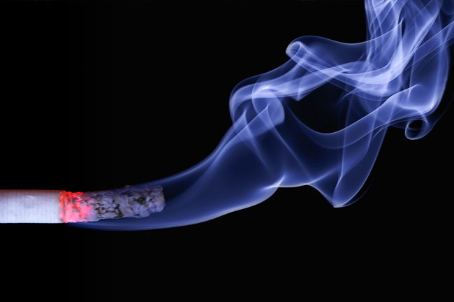 Burning cigarette with smoke