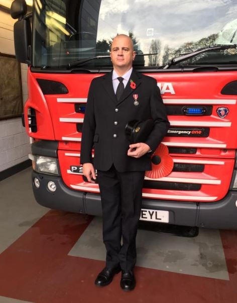 Firefighter, Alec Elwell, infront of truck